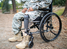 A left leg amputee in military fatigues sitting in their wheelchair