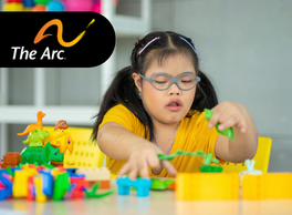 Logo: The Arc. A young child with a developmental disability plays with plastic building toys and dinosaur toys at a table.