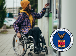 A woman in a wheelchair puts her card into an ATM. Logo: Department of Labor.